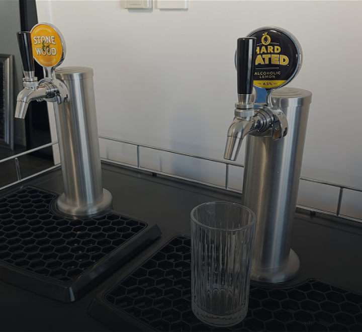 Draught beer pouring into a glass from a tap