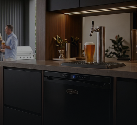 Keg fridge and tap tower built into a home bar