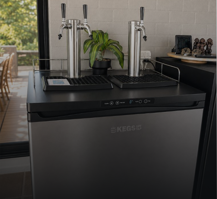 Keg fridge and tap tower built into a home bar