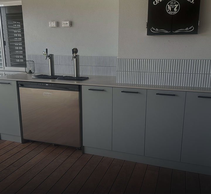 Keg fridge with twin taps built into a balcony bar