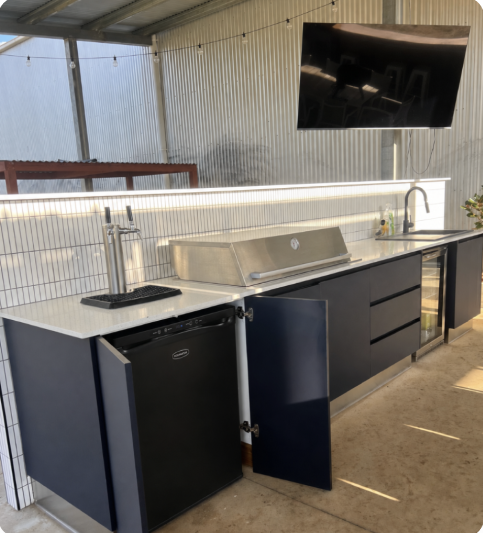 Home Bar keg fridge with twin taps built into a dark home bar
